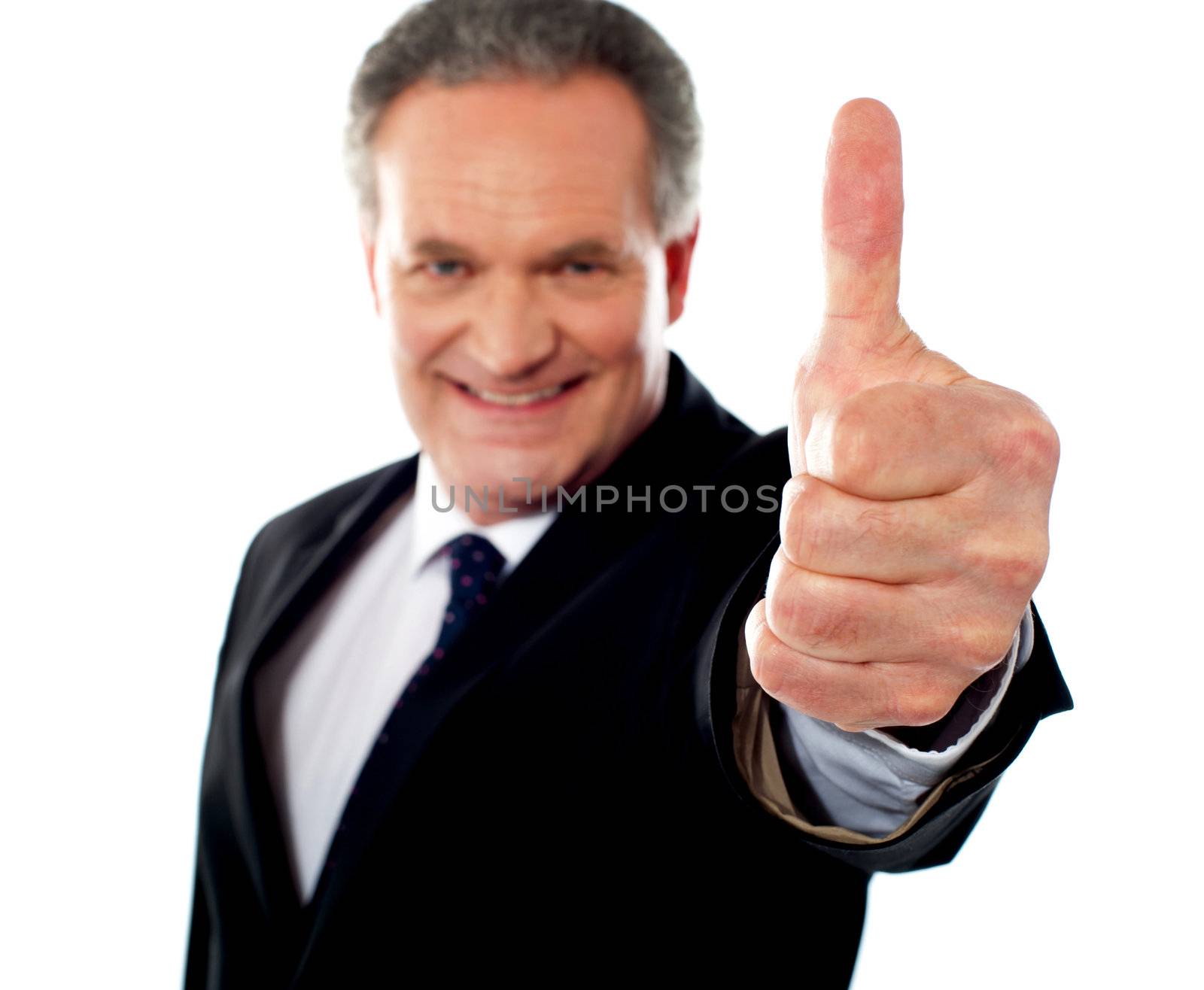 Successful entrepreneur gesturing thumbs-up by stockyimages