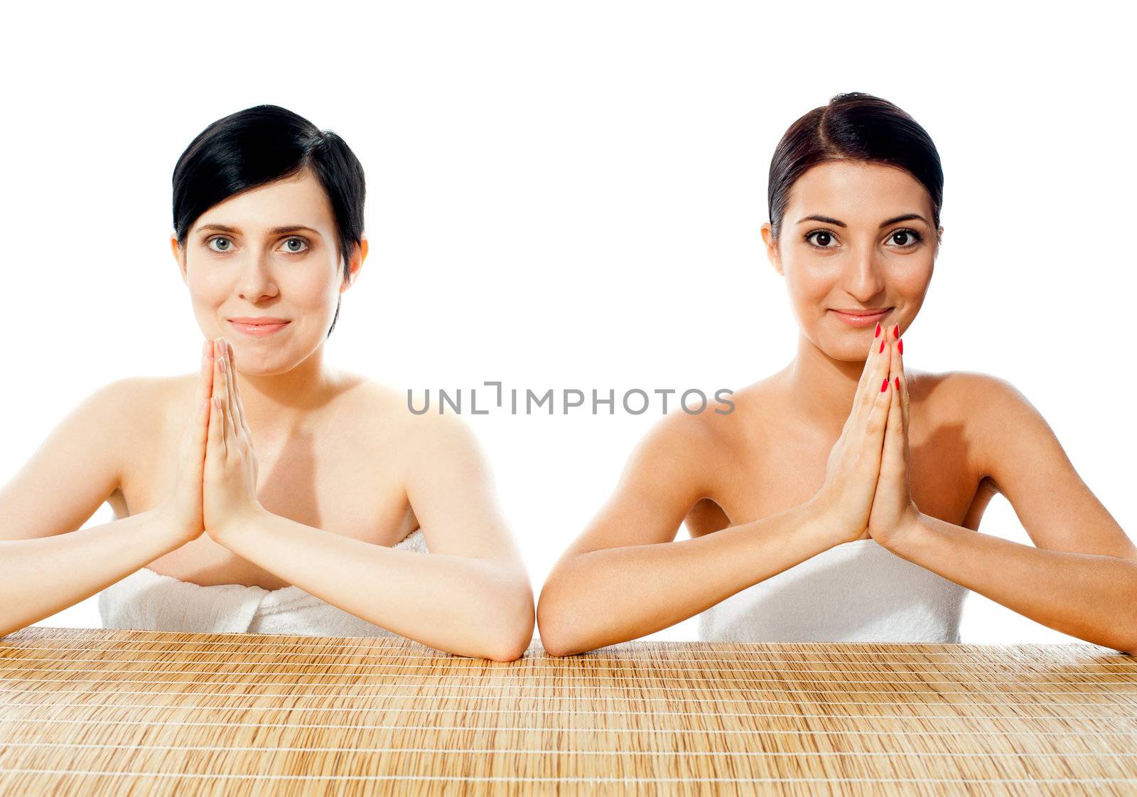 Two pretty ladies posing in traditional welcoming gesture