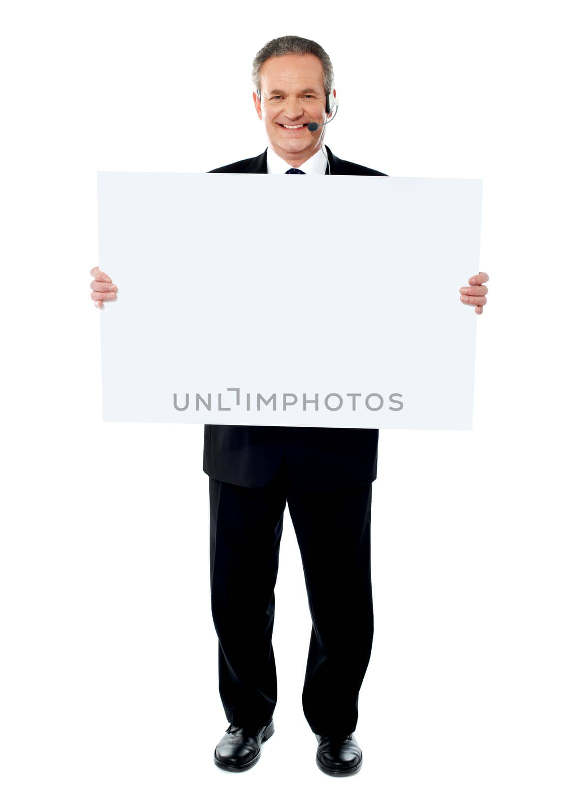 Businessman holding a blank billboard by stockyimages