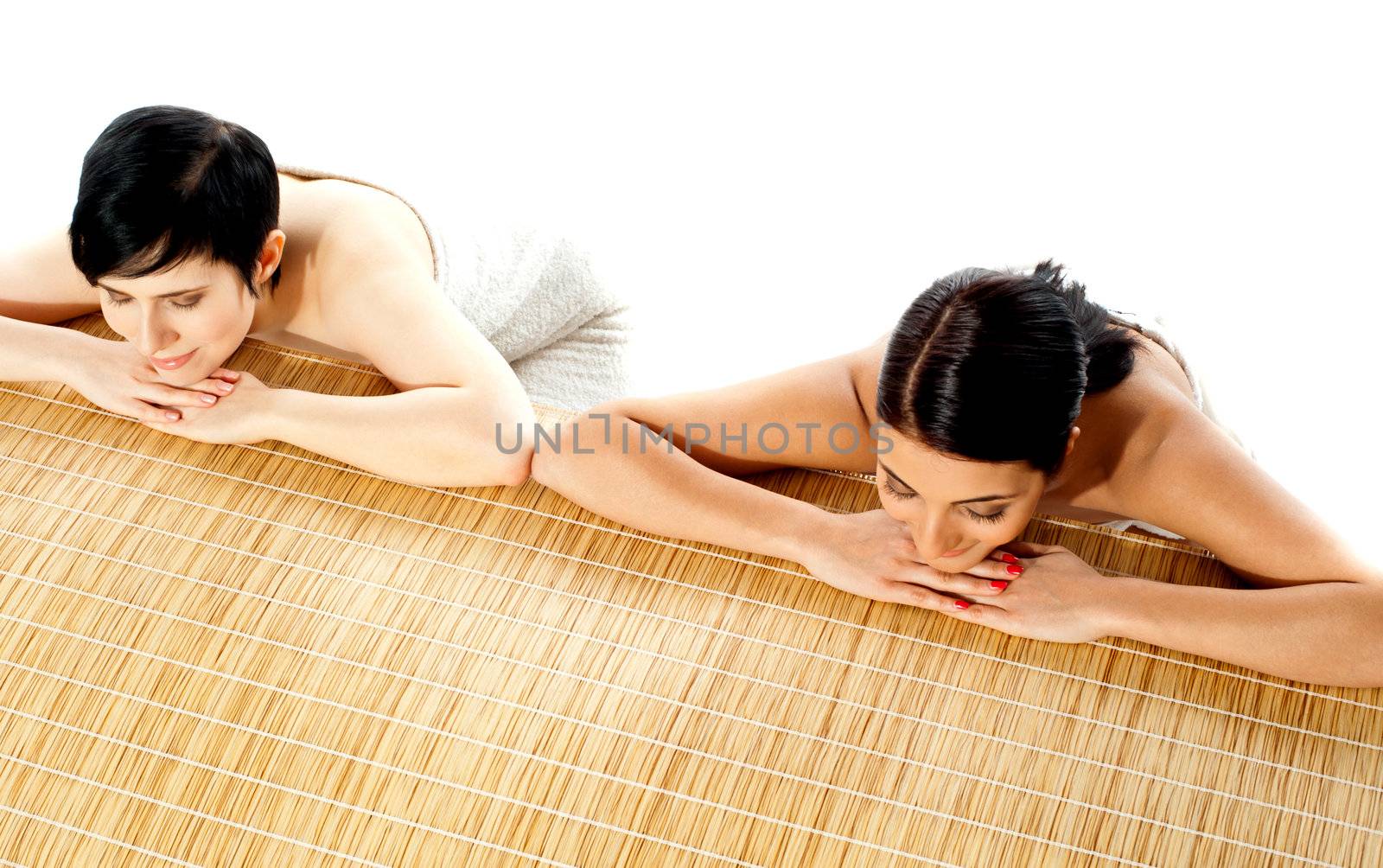 Portrait of young beautiful women in spa environment, relaxing with eyes closed