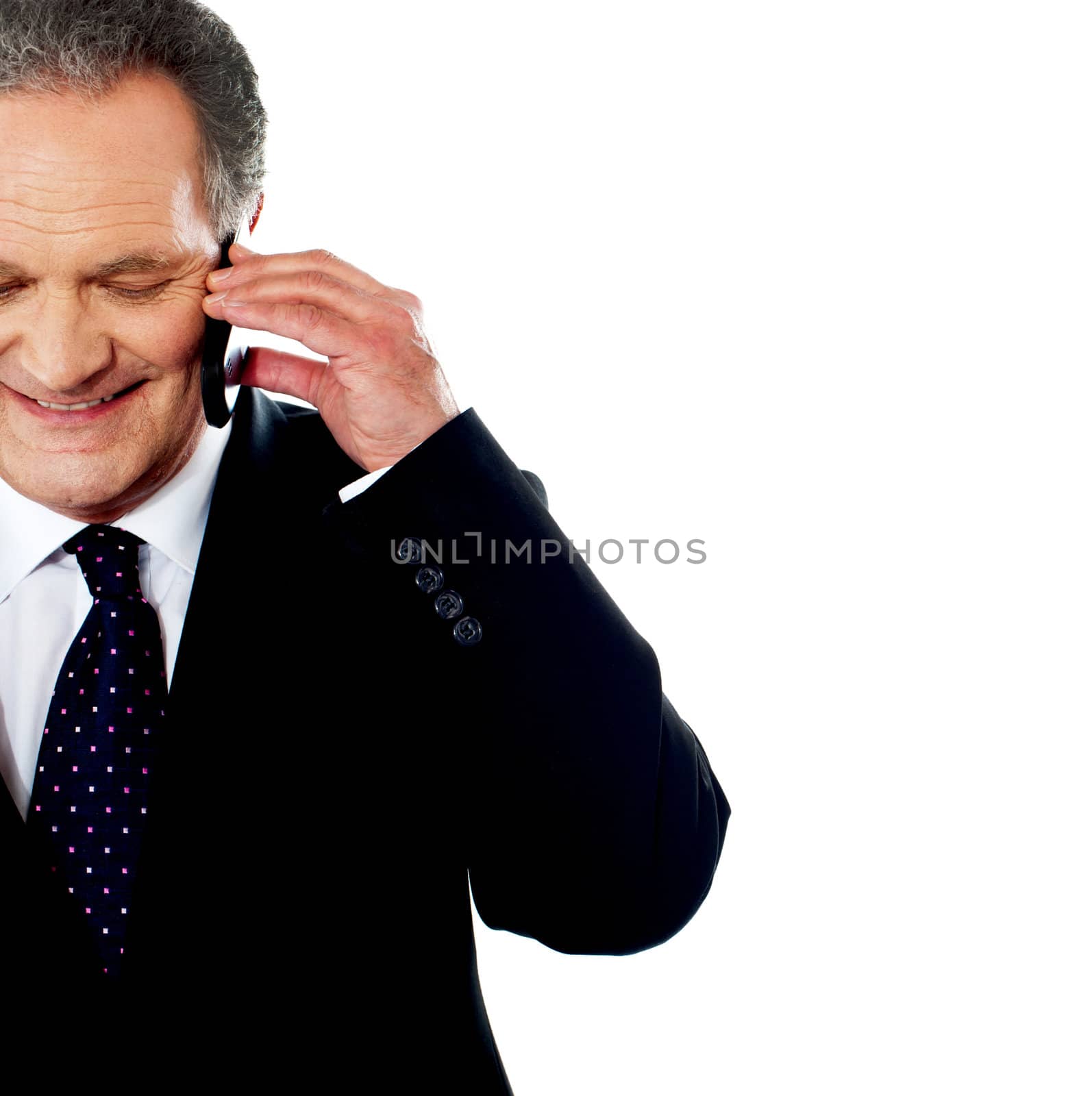 Professional communicating on his phone against white background