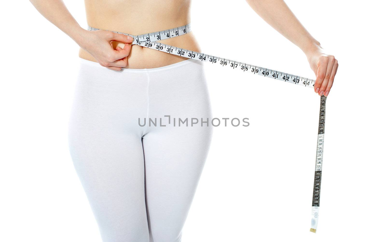 Woman measuring her abdomen by stockyimages