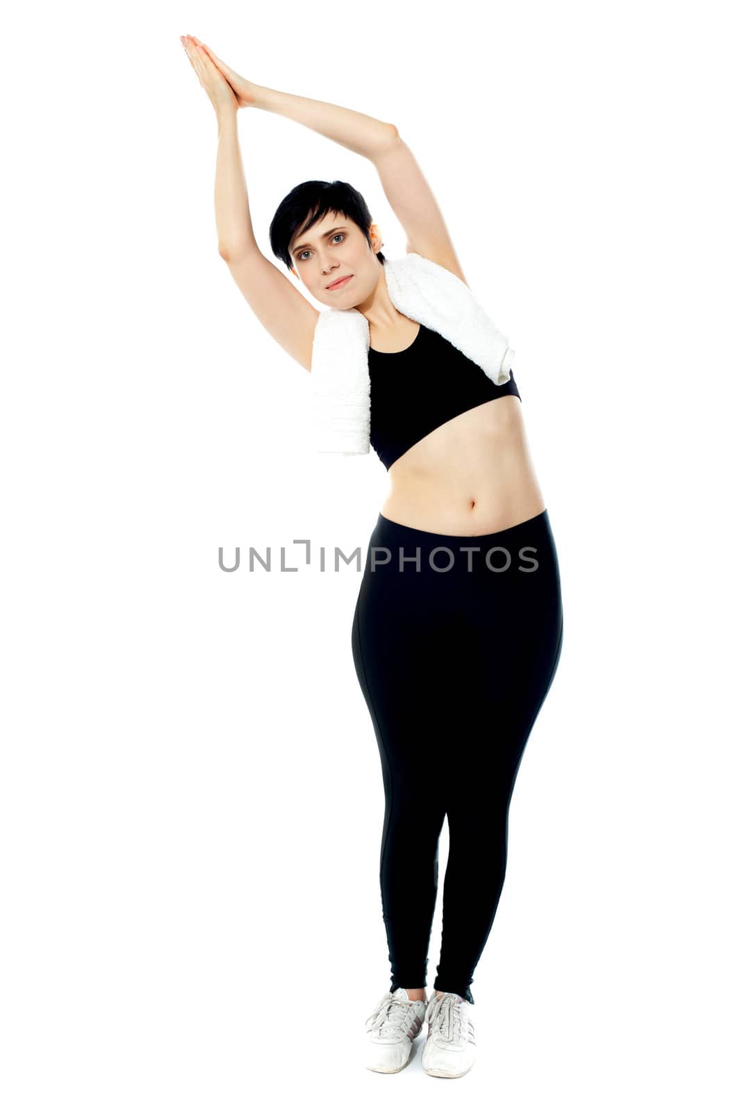 Fit female instructor doing stretching exercise isolated over white