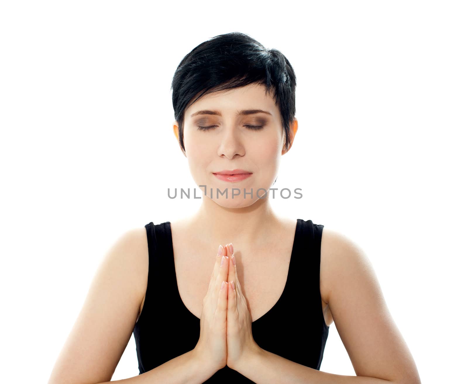 Closeup of pretty girl. Hands held together doing yoga