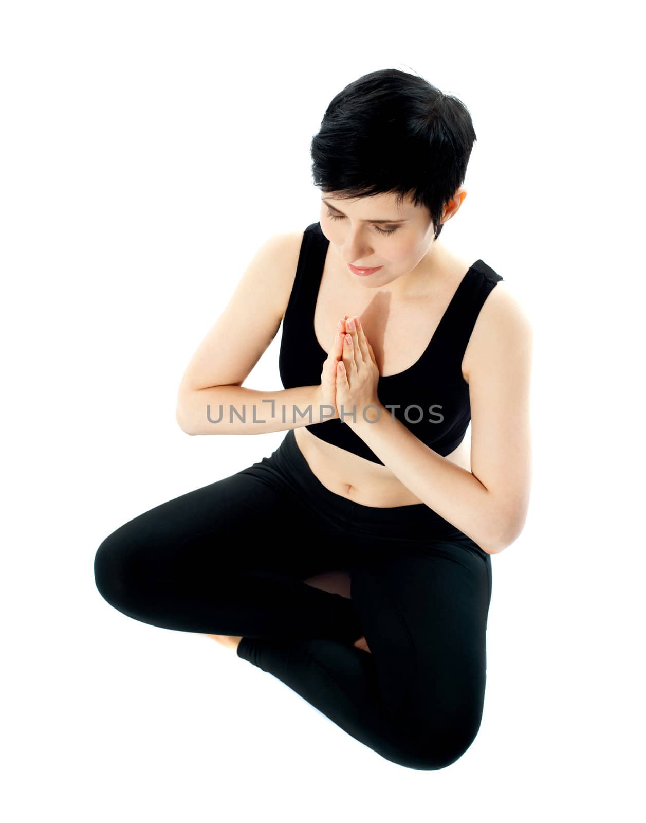 Young woman practicing yoga in the lotus position, isolated on white