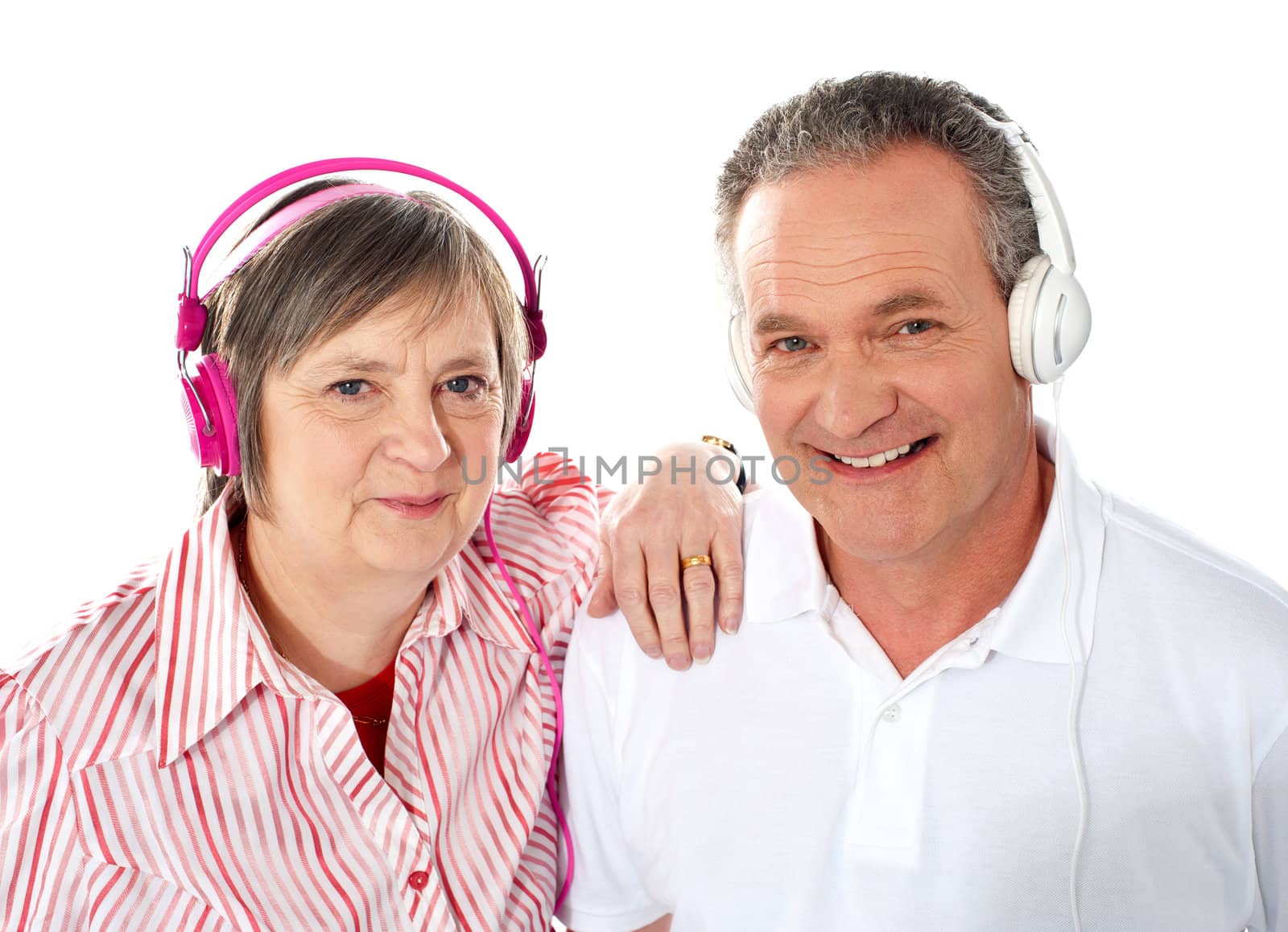 Portrait of a cute senior couple listening to music together against white background