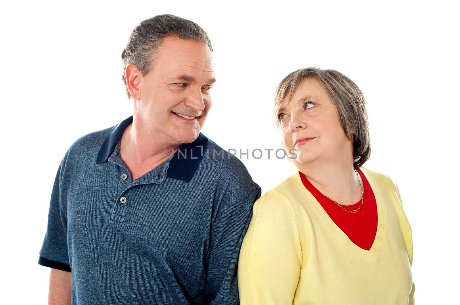 Attractive senior couple being playful. Posing back to back