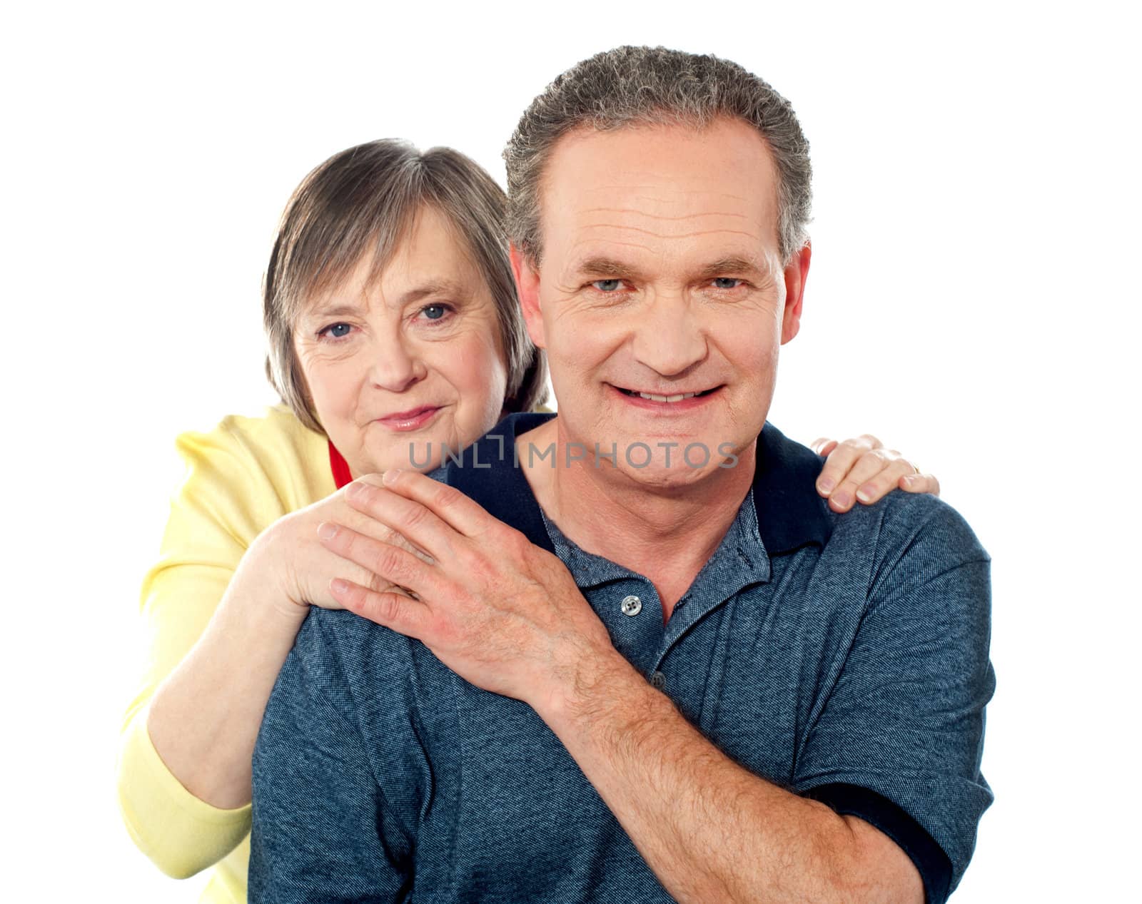 Portrait of happy aged smiling couple posing against white background