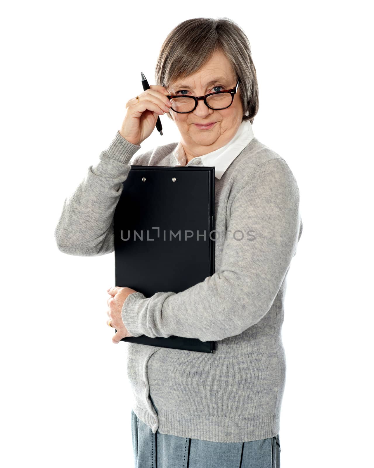 Corporate woman looking at you from within her eyeglasses. Carrying important papers