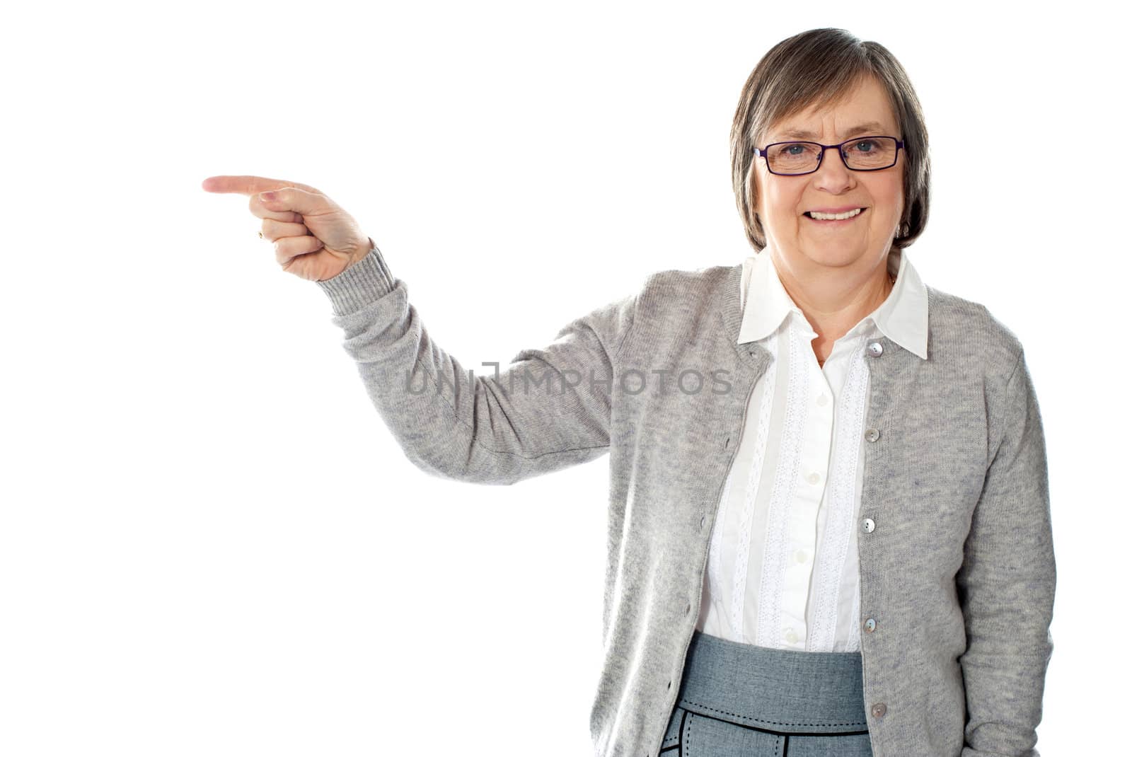 Portrait of beautiful aged woman pointing at copyspace