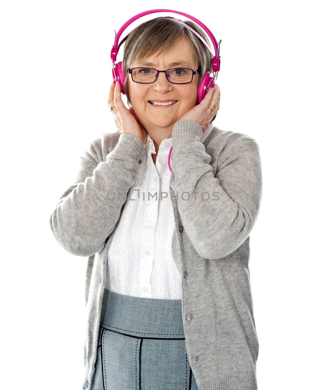 Attractive old lady wearing headphones listening music