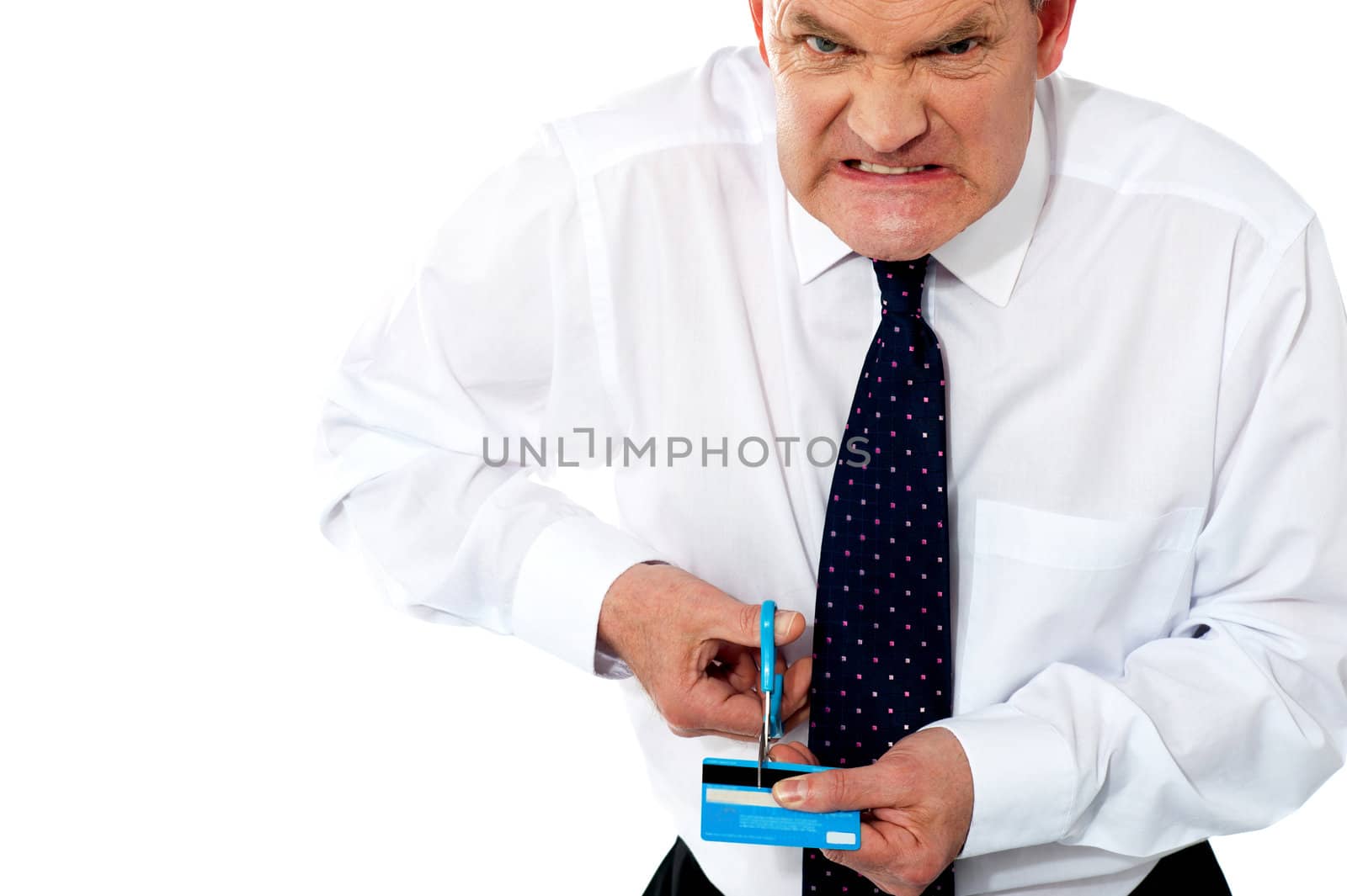 Frustrated businessman cutting his credit card. Extremely disappointed