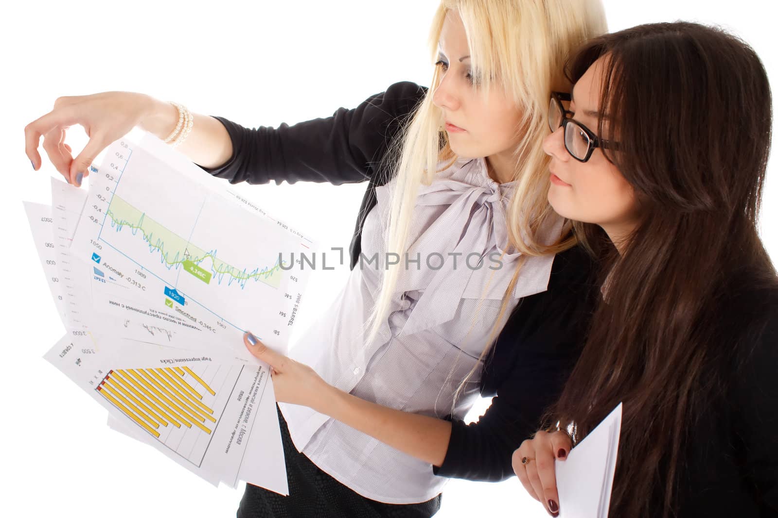 Two businesswoman looks on the graph on white background.