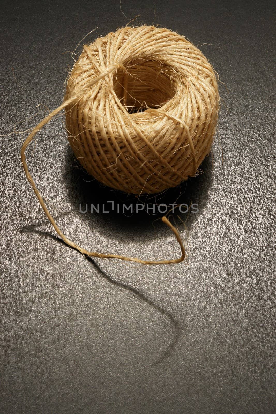 a packet.cord in dramatic lighting on black background..