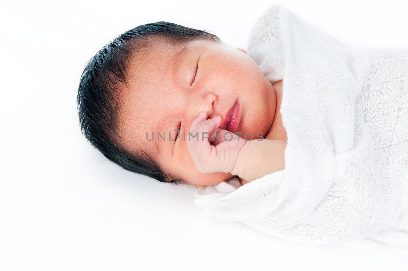 Portrait of a newborn infant baby sleeping gracefully over white background.