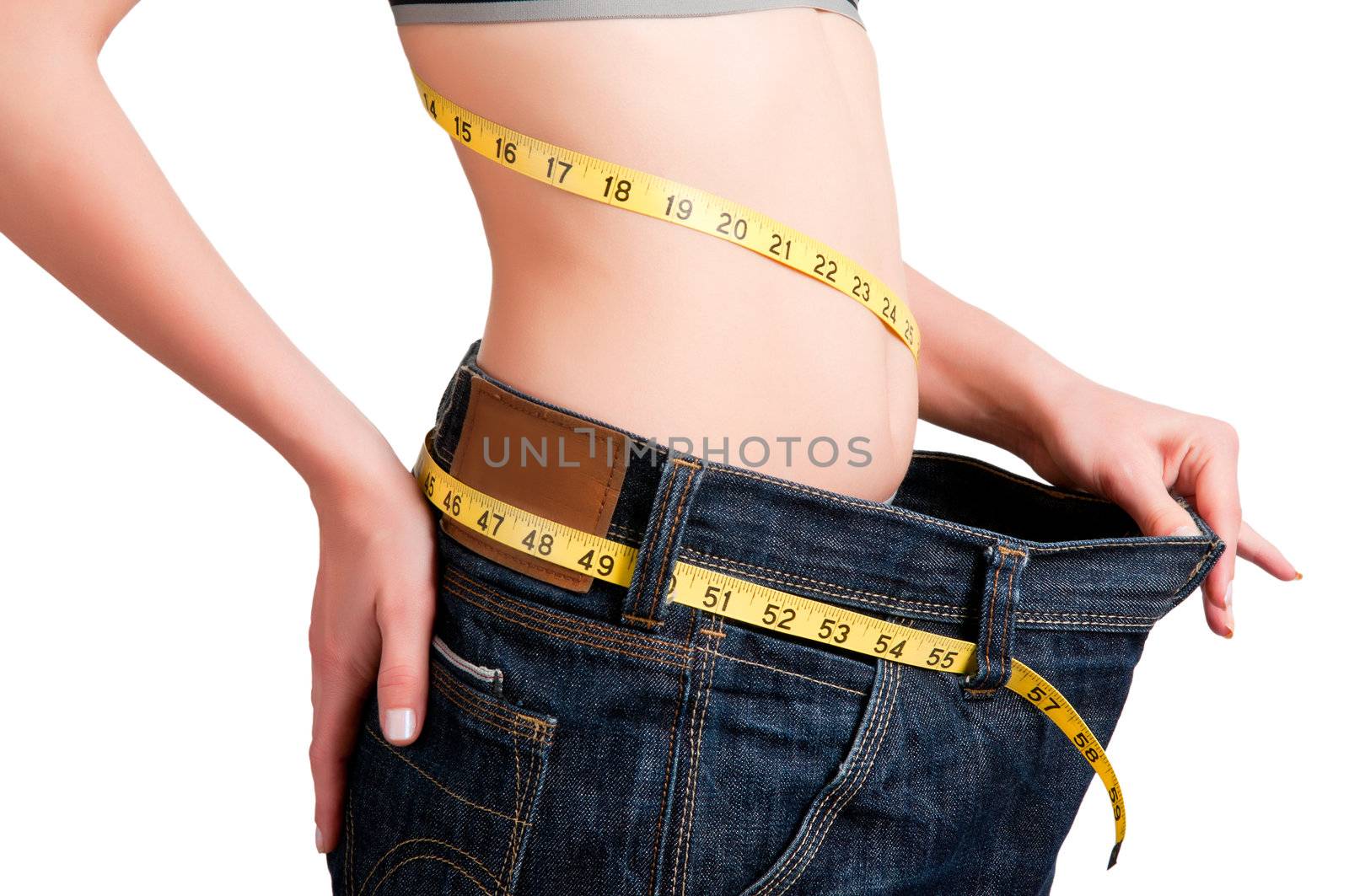 Woman seen how much weight she lost. Isolated background.