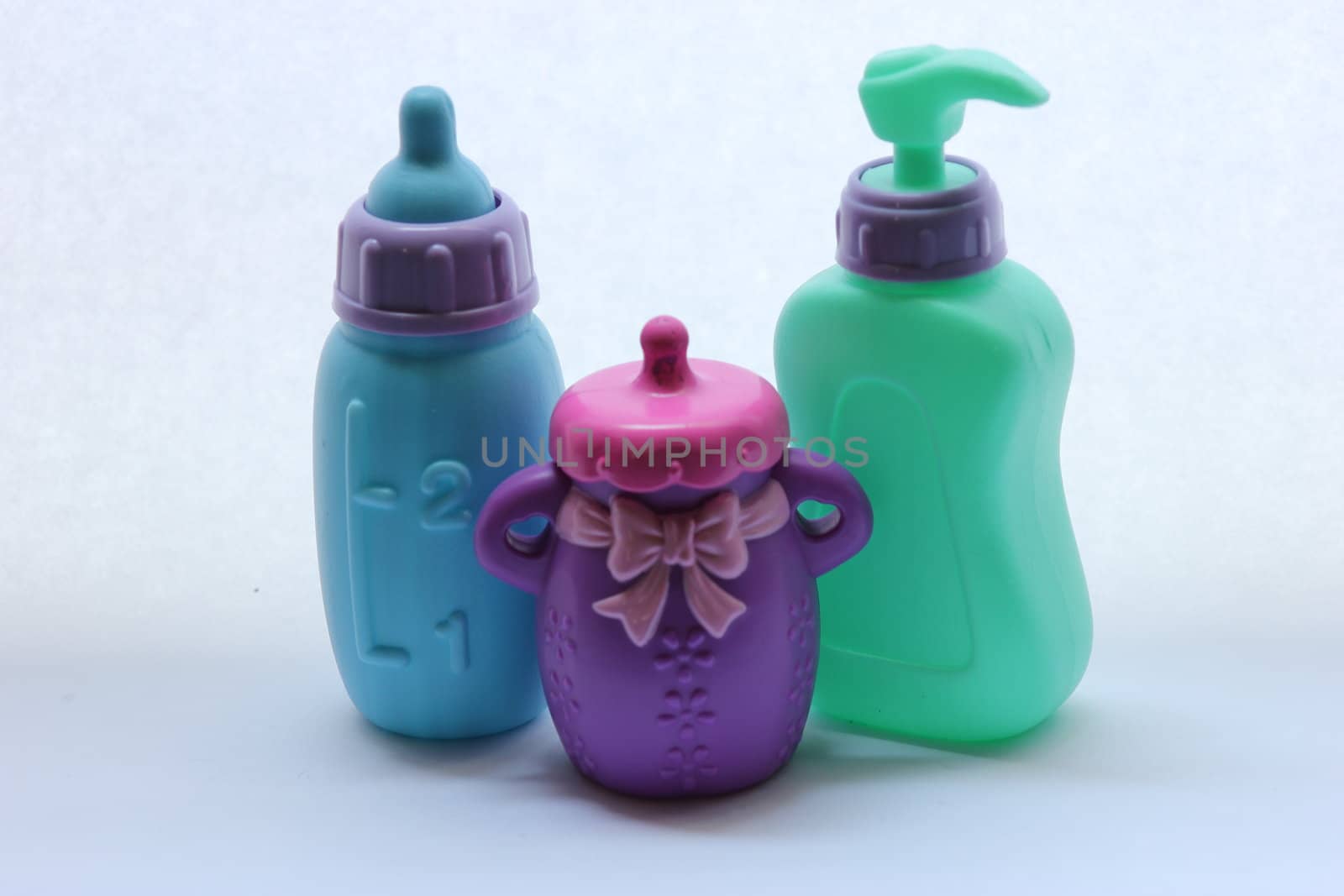 Toddler toys that include two bottles and a soap dispenser.