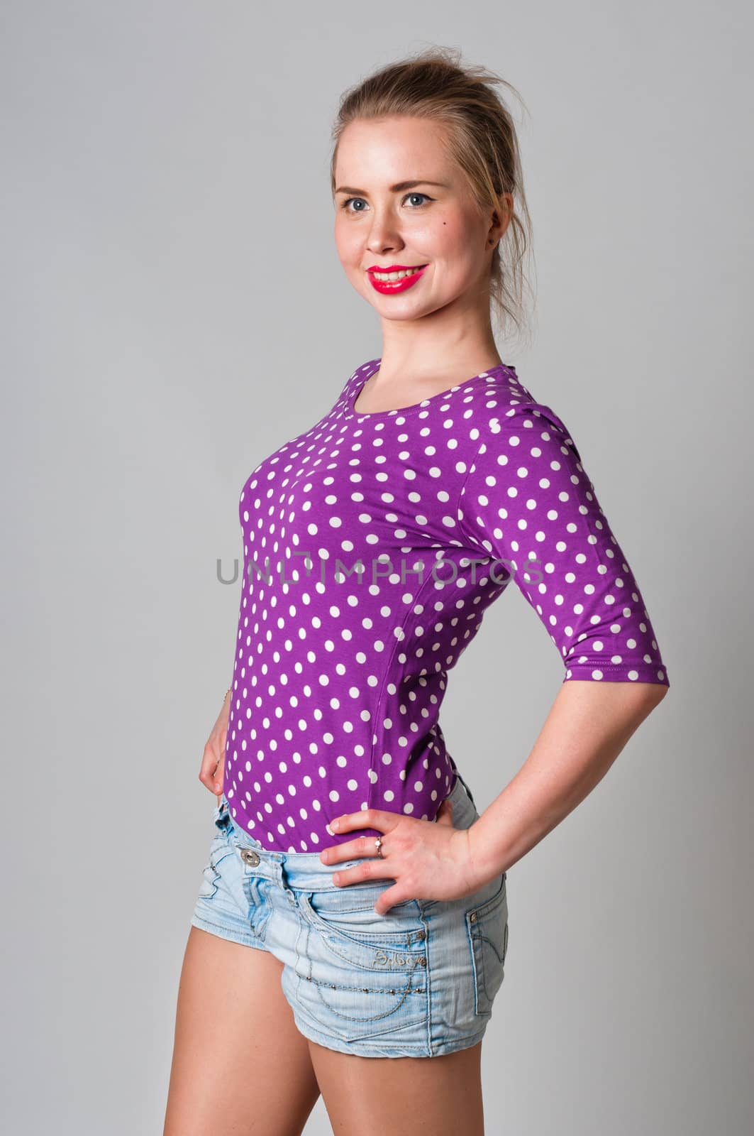 Pin up girl standing and smiling portrait, studio shot