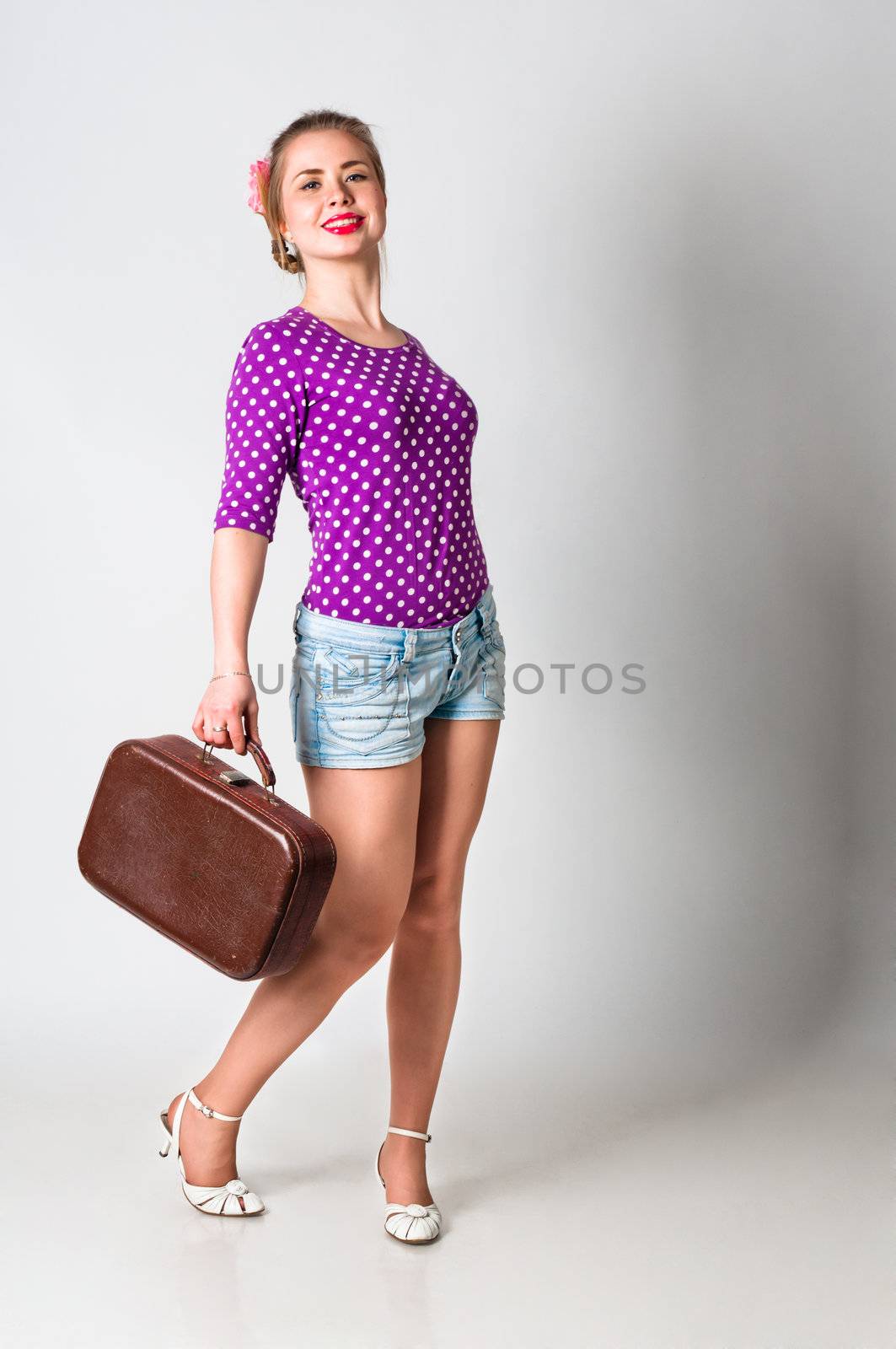 Pin up girl standing with bag by dmitryelagin