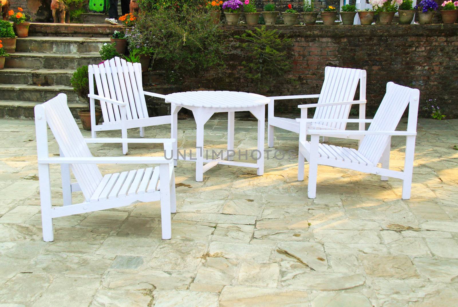 White chairs and table in a garden