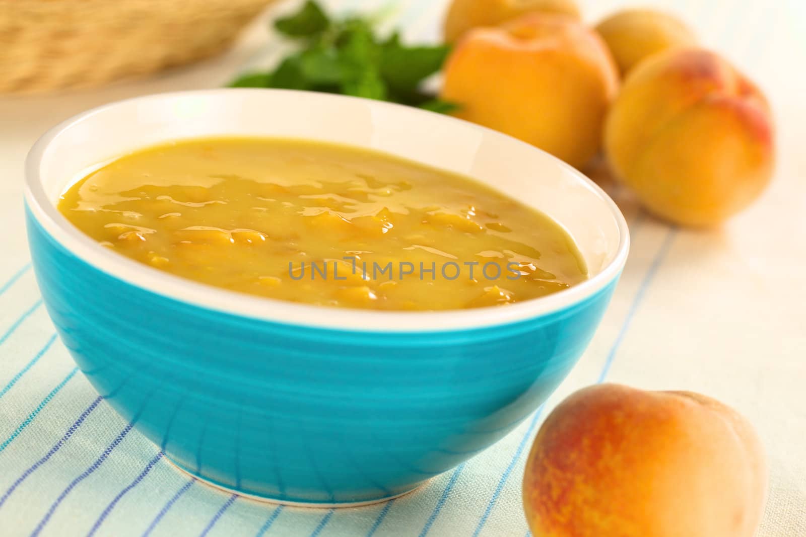 Refreshing cold peach soup in blue bowl (Selective Focus, Focus one third into the soup)