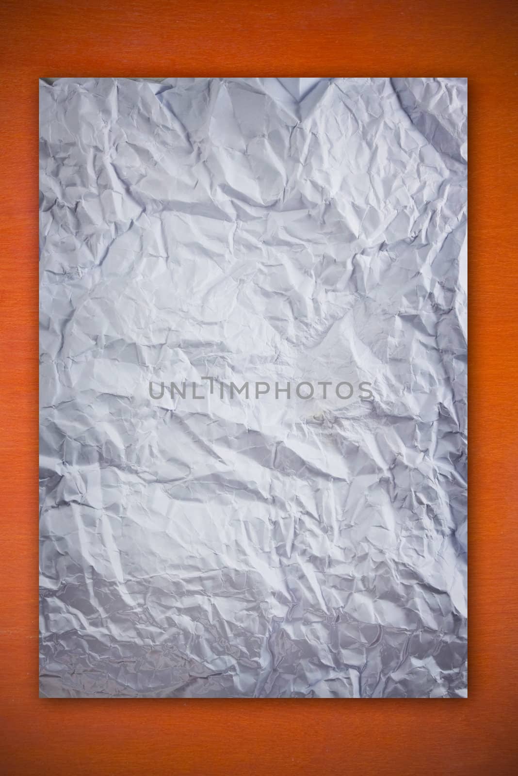 Blank white paper on wood wall as background