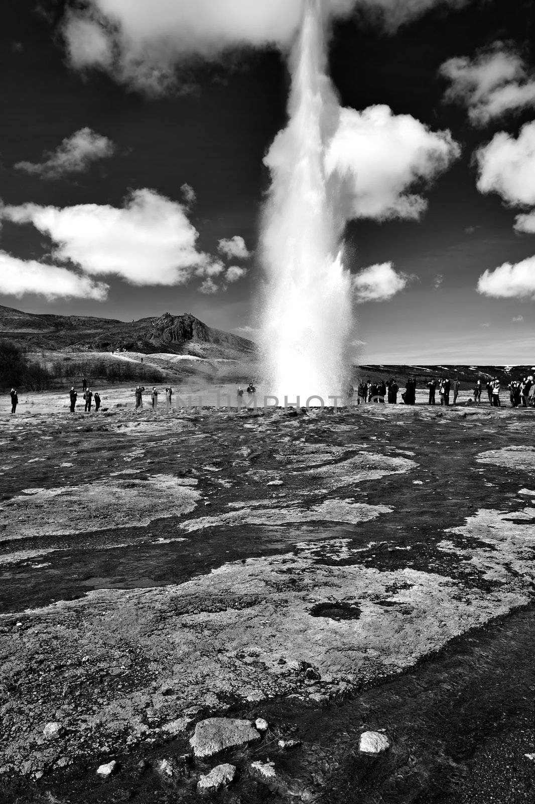 Icelandic Geyser erupts, with blue sky in the background