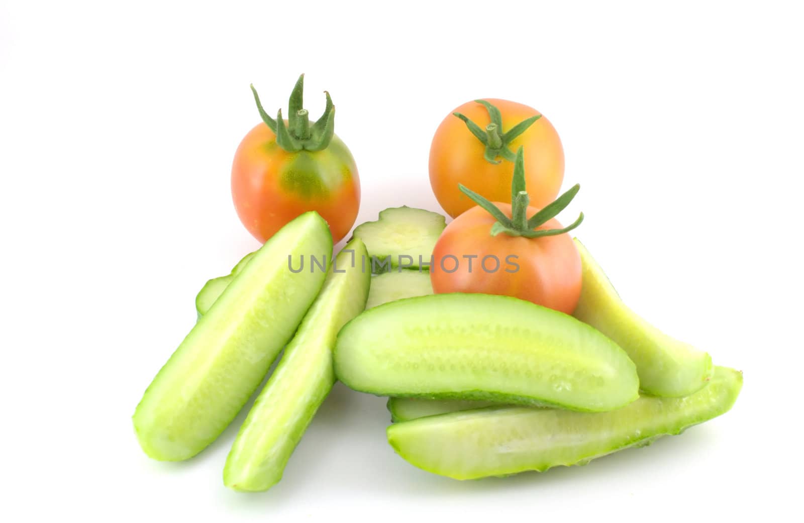 Cutted cucumber and tomatoes over white