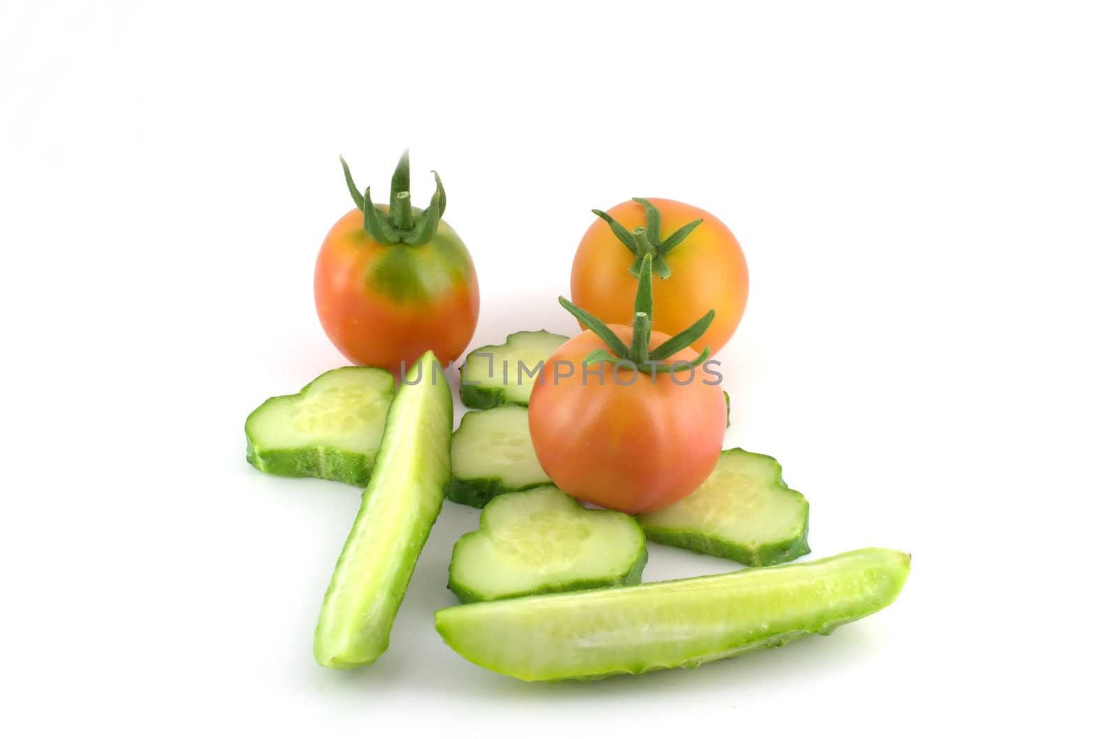 Cutted cucumber and tomatoes over white