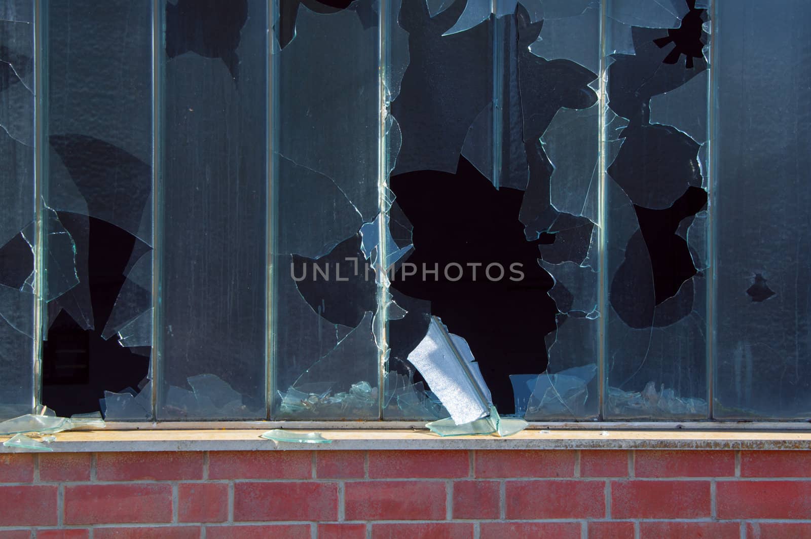 Broken window and brick wall of an abandoned factory