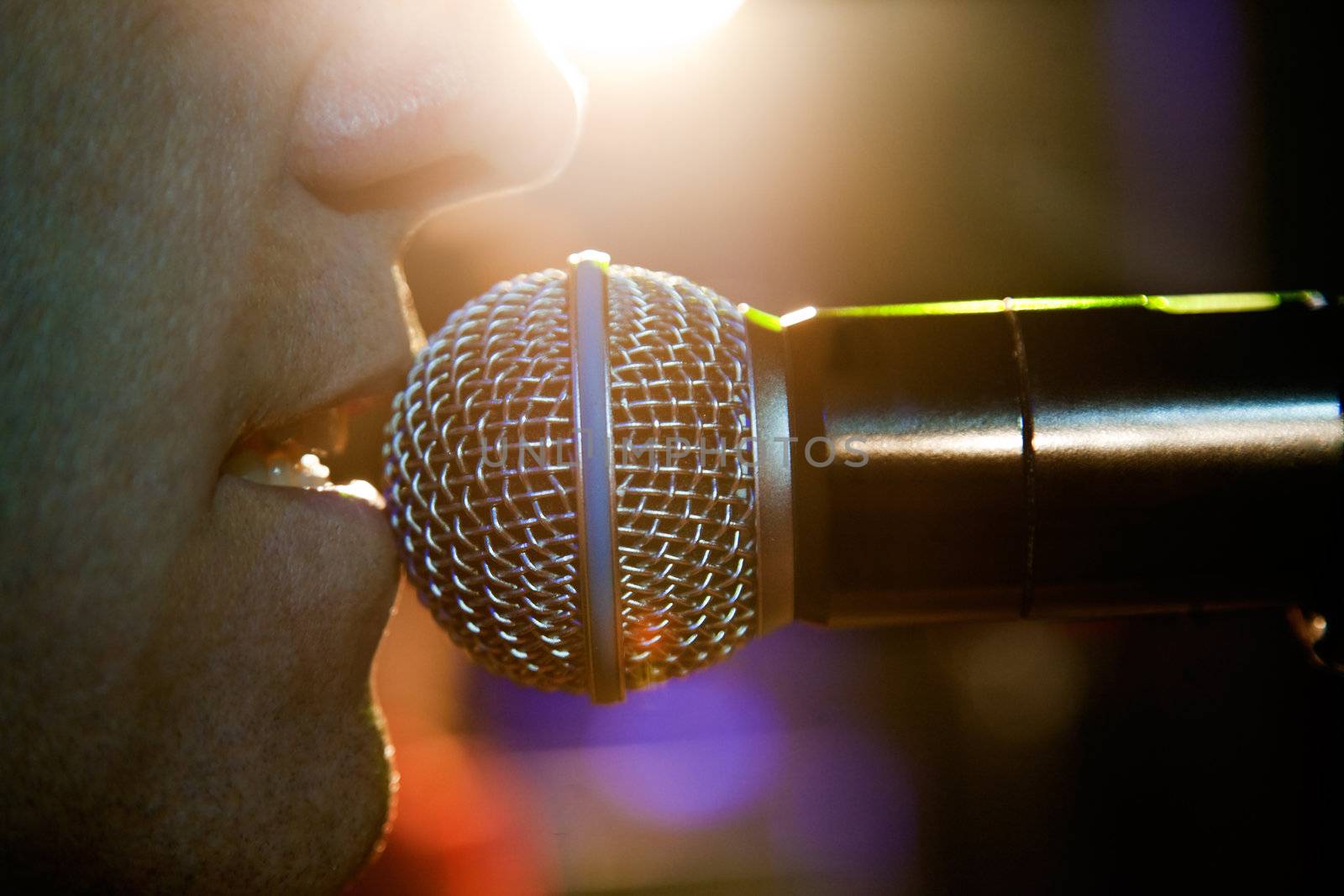 Close up image of singer and microphone on stage