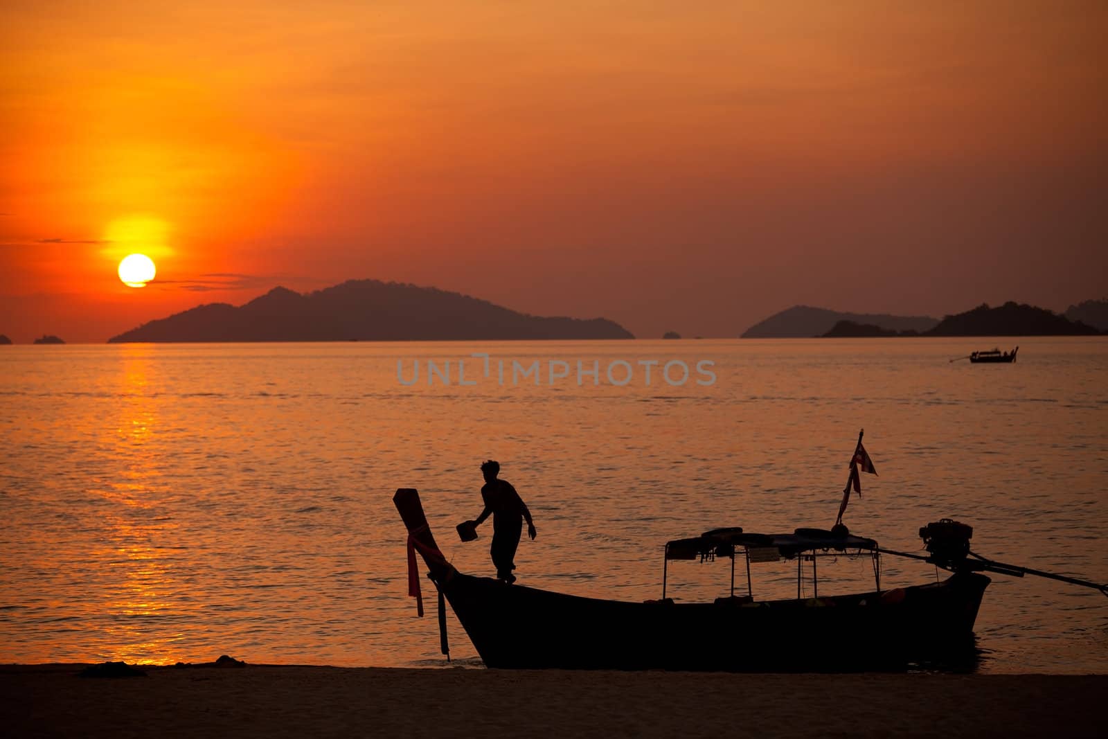 Sunset with fisherman boat in Andaman sea , South of Thailand.