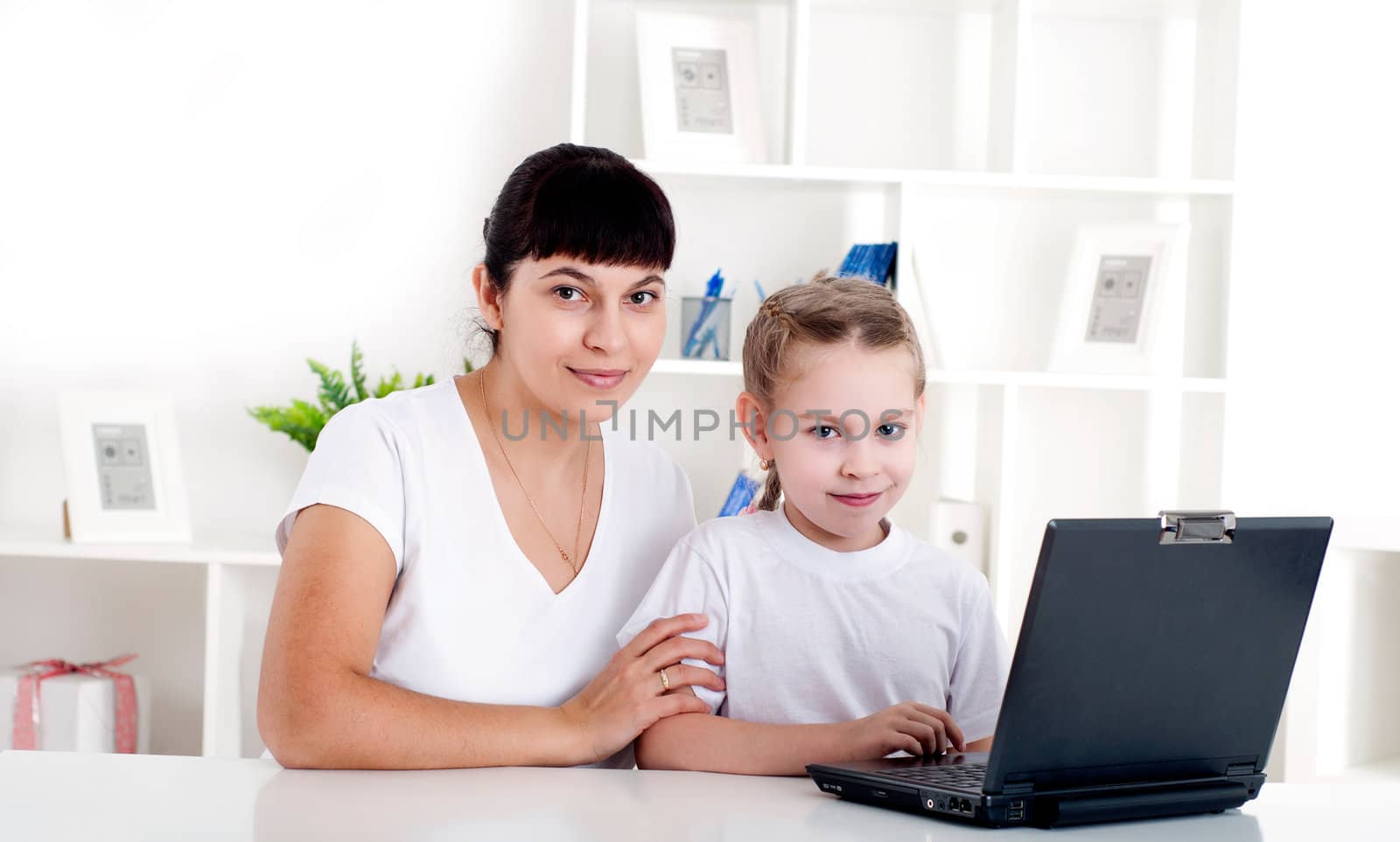 Mom and daughter are working together for a laptop by adam121