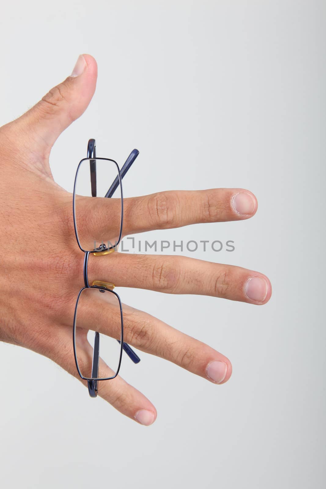 Hand holding folded glasses