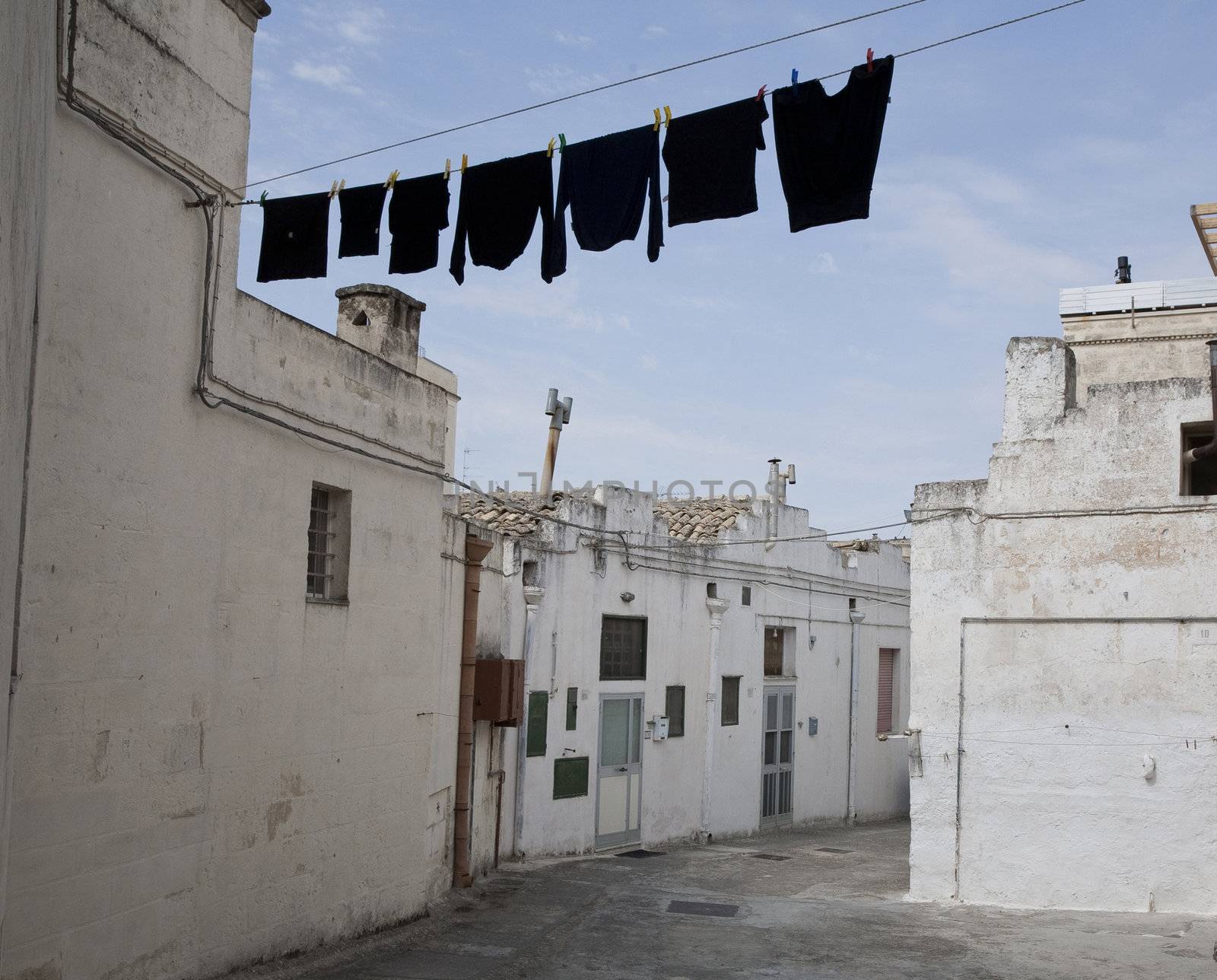 Washing day for the black clothes - Sassi, Matera - region of Basilicata, Italy.