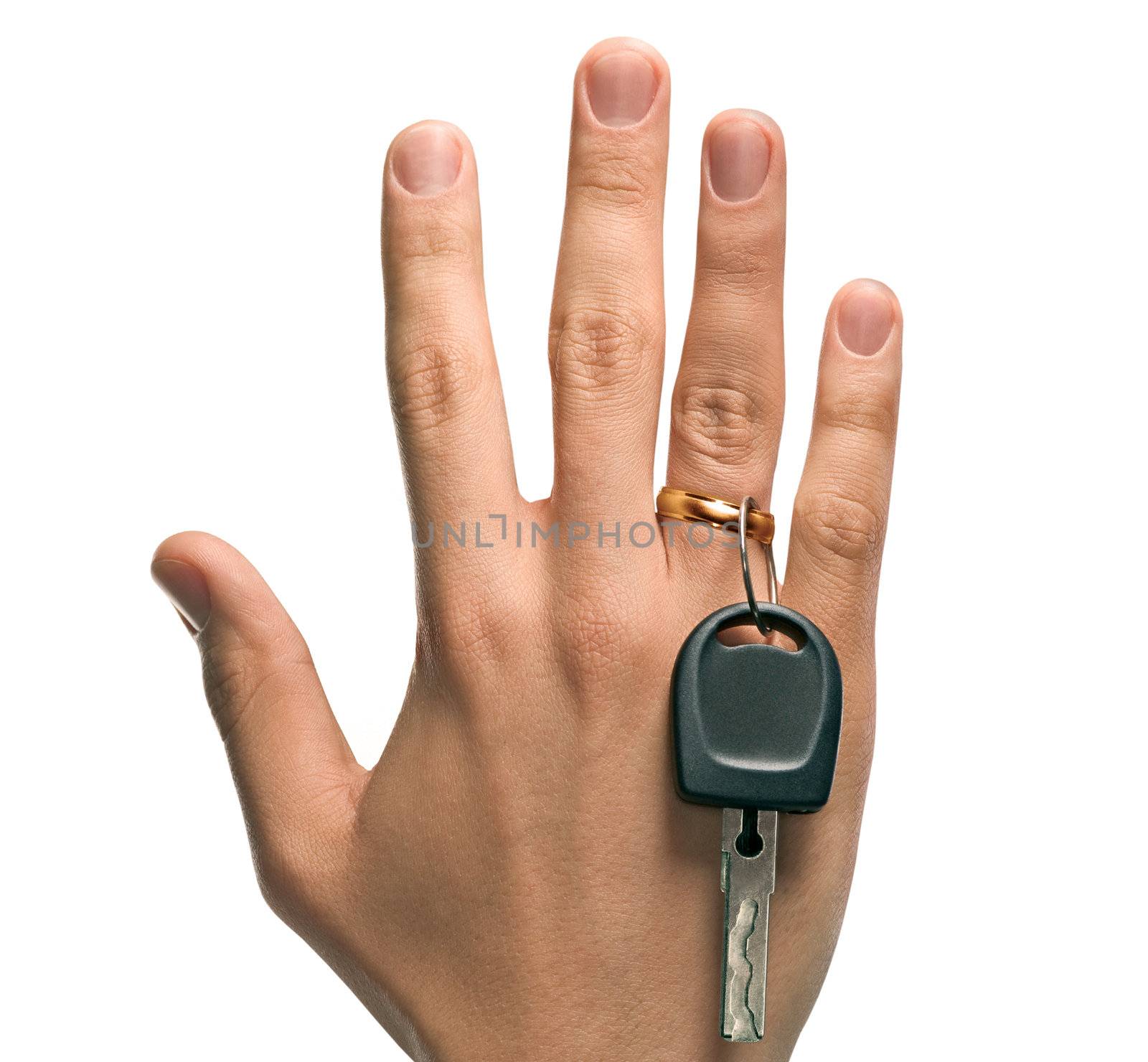 A concept image of a mans hand holding a key and a wedding ring