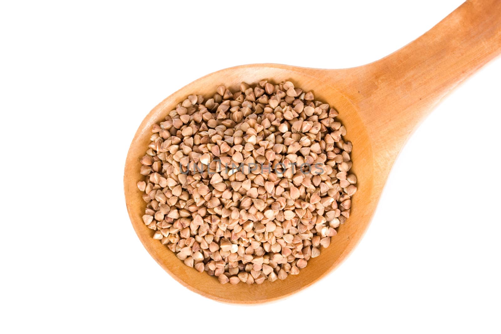 Buckwheat in wooden spoon close up isolated