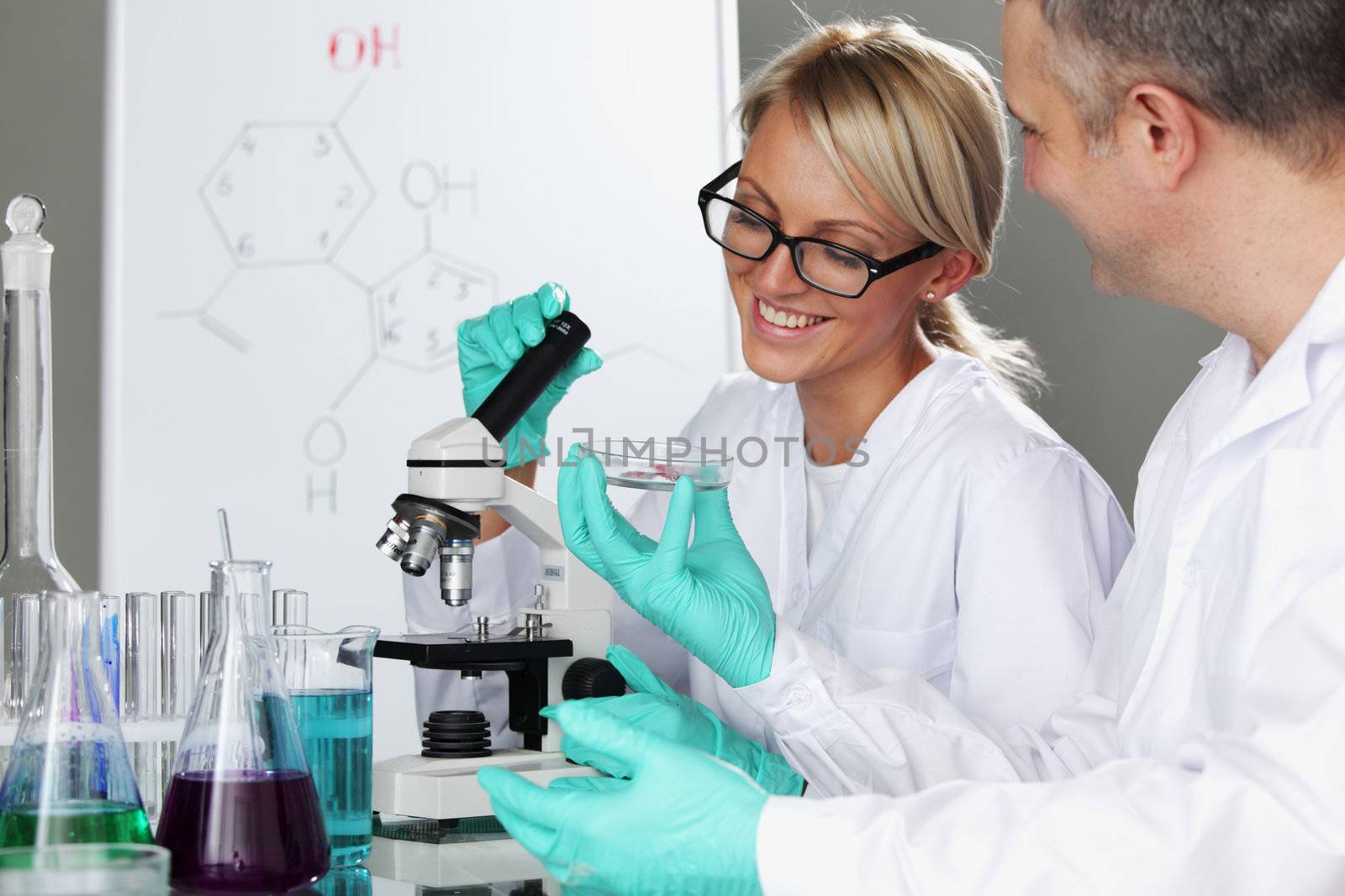 two scientist in chemical lab conducting experiments