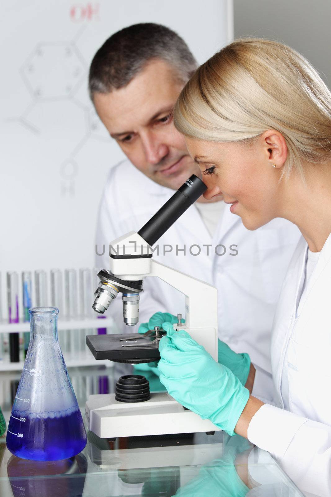 two scientist in chemical lab conducting experiments