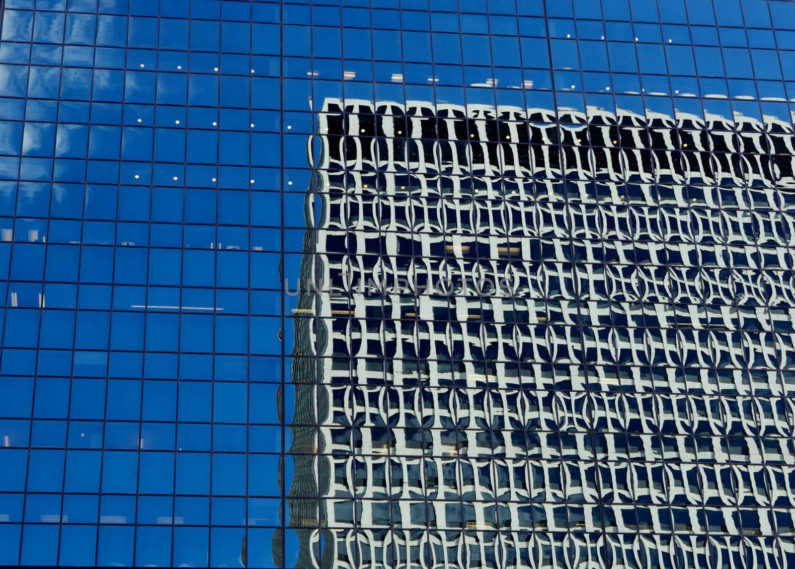 Interesting reflections on the mirrored window surface of an office building