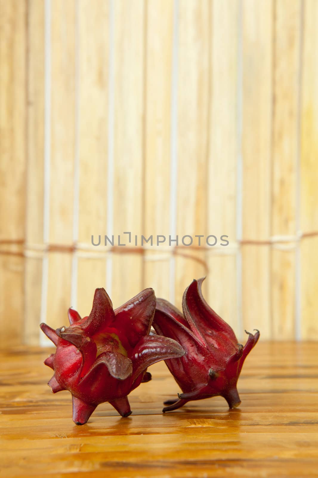 Hibiscus sabdariffa or roselle fruits on wood background