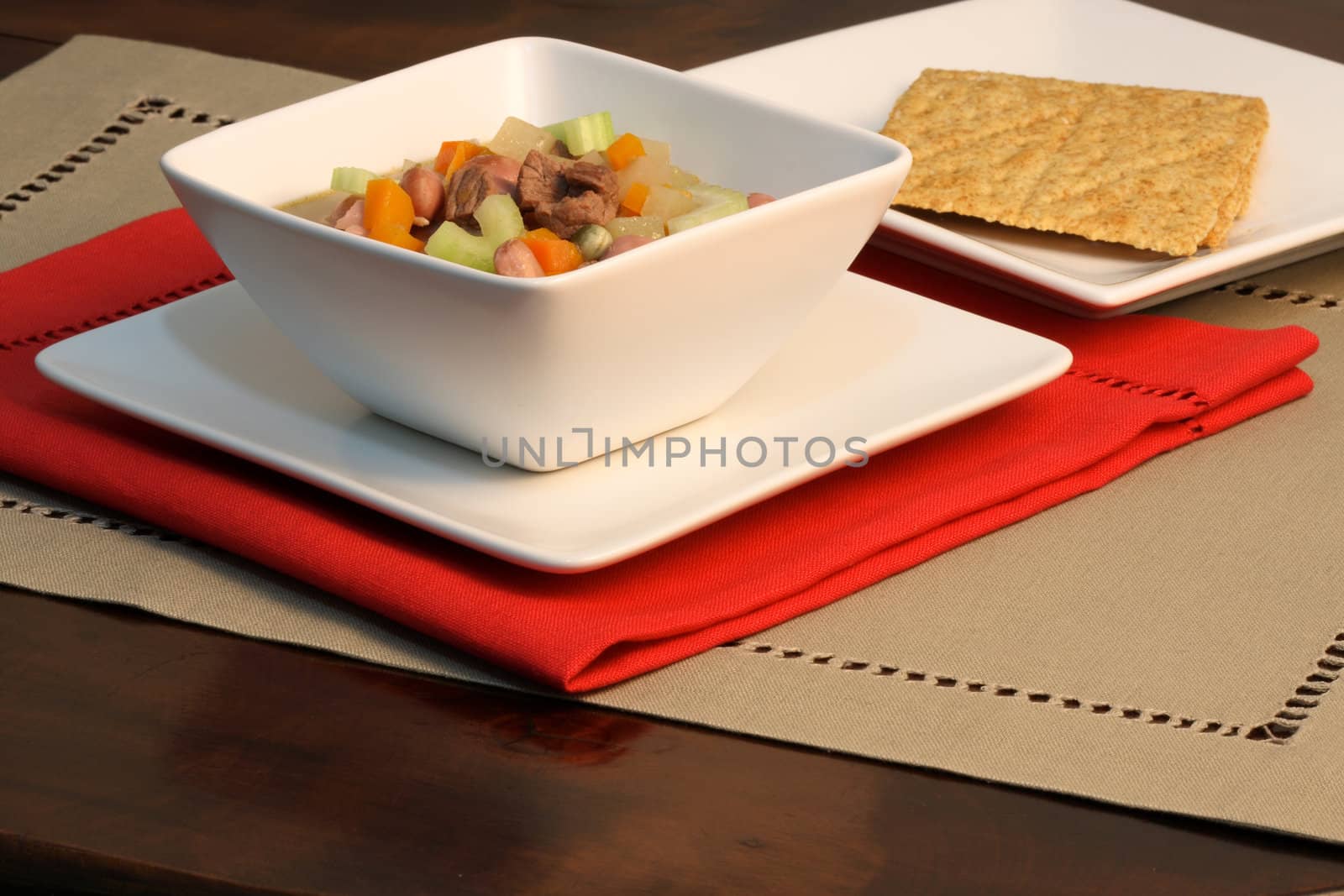 beef and veggies healthy soup on fine linen table 