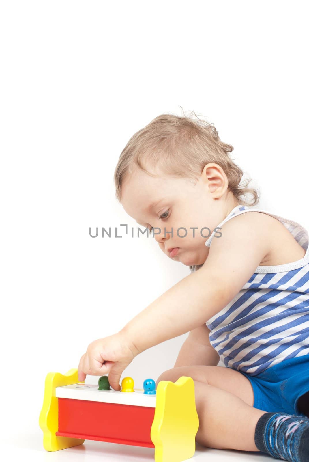 Small baby boy with a toy isolated on white