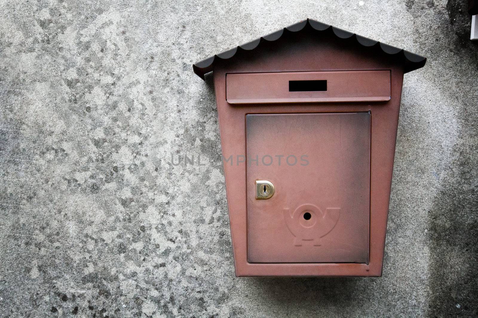 metallic mailboxes on old wall background by motorolka