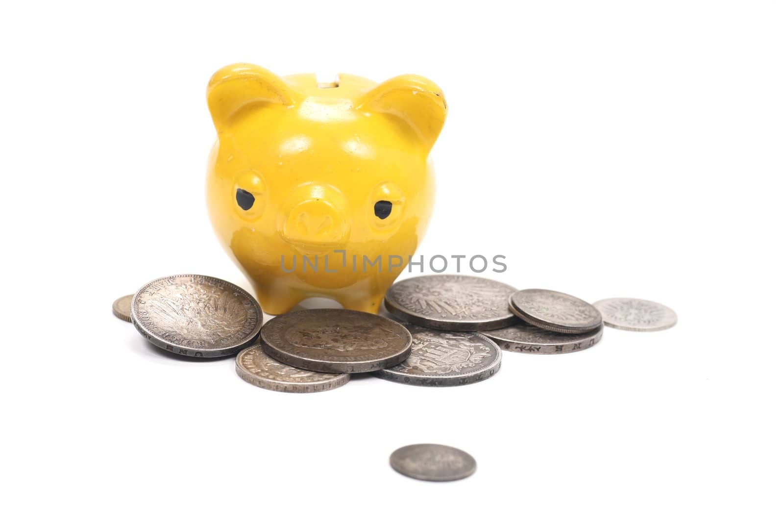 yellow piggy bank with very old coins............