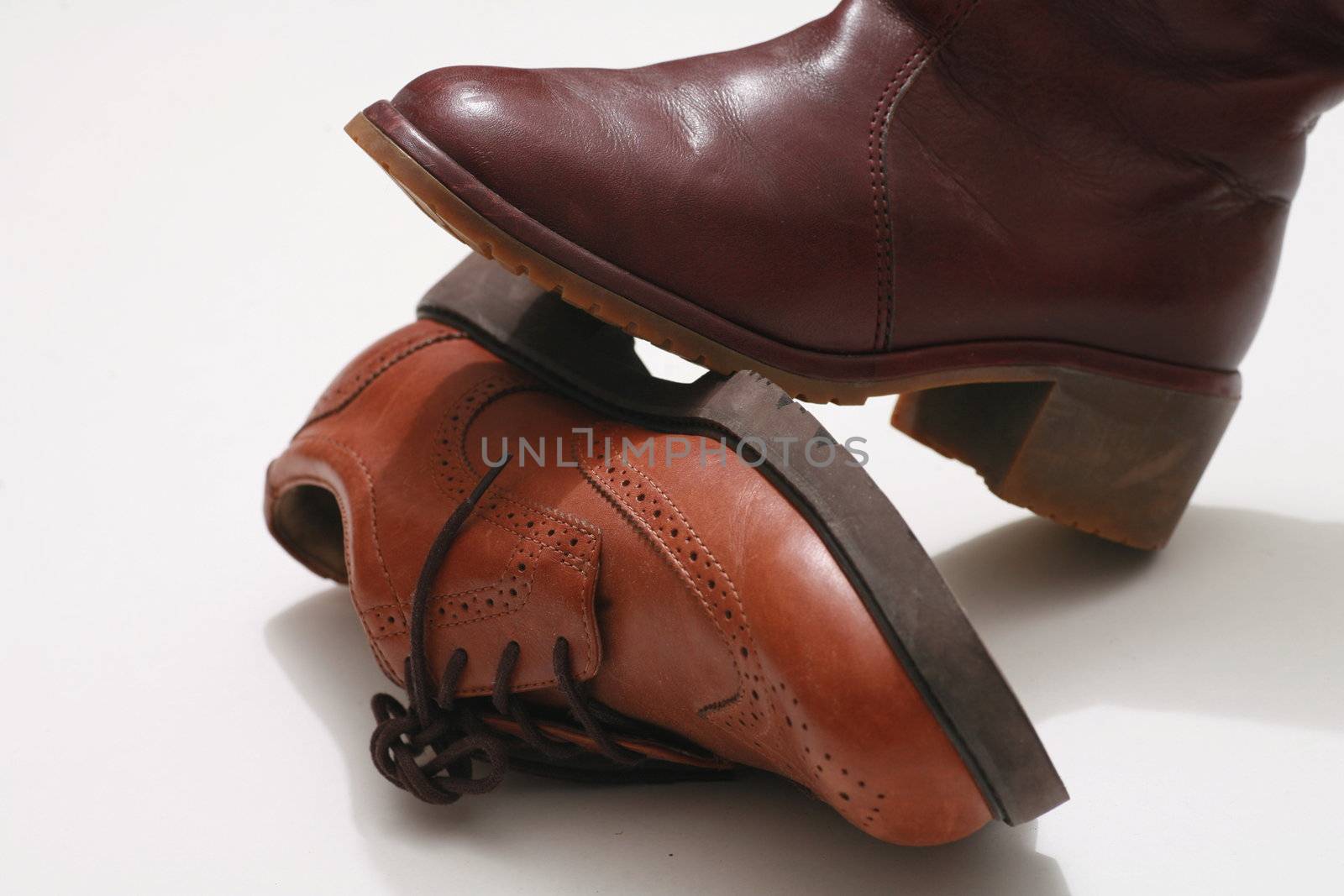 Close-Up of a boot standing on another leather shoe