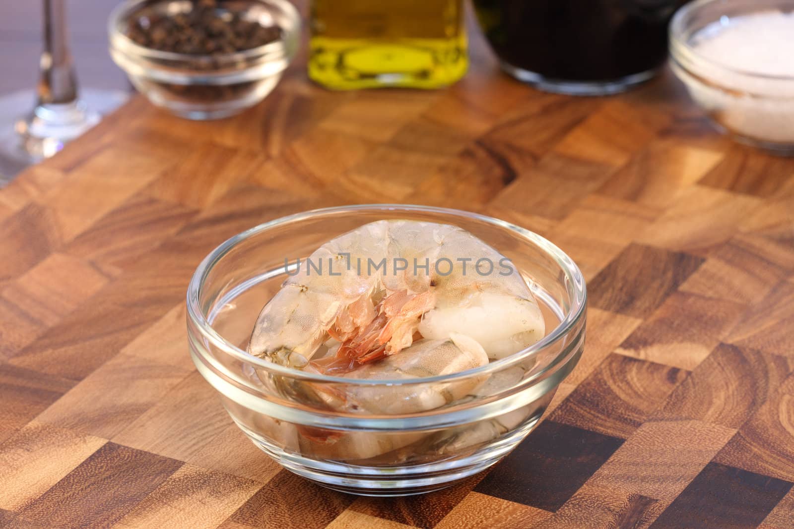 raw fresh prawns with ingredients  on background over fancy cutting board shallow dof  