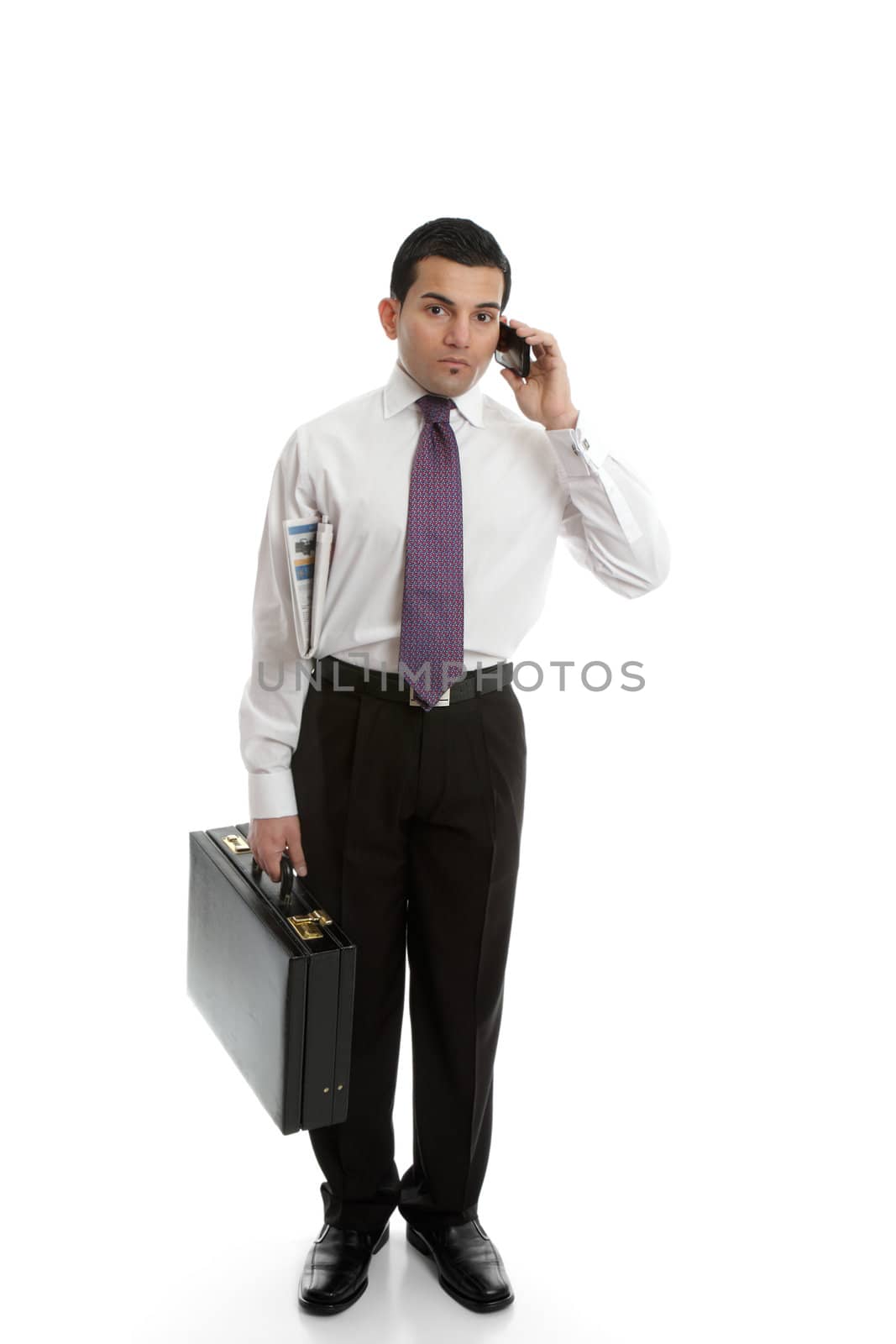 A businessman carrying a black briefcase and using a mobile cell phone.
