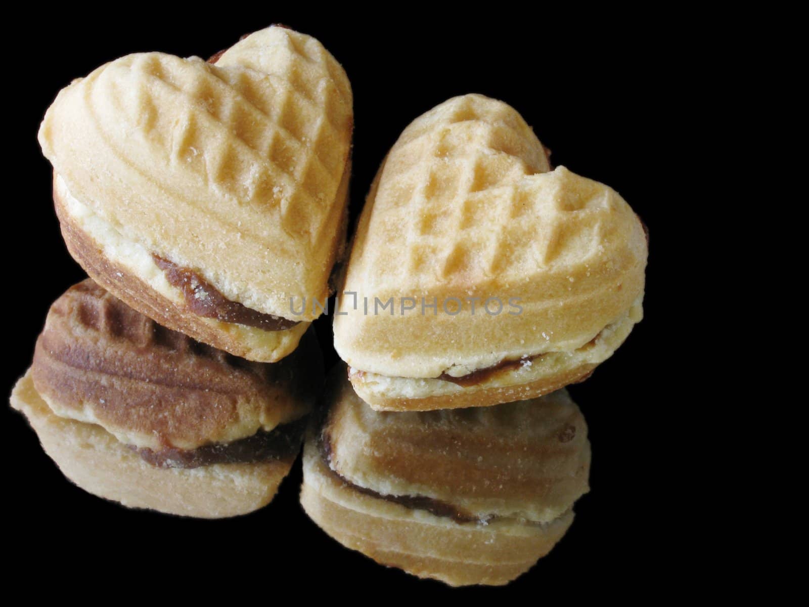 two heart-shaped biscuits over black