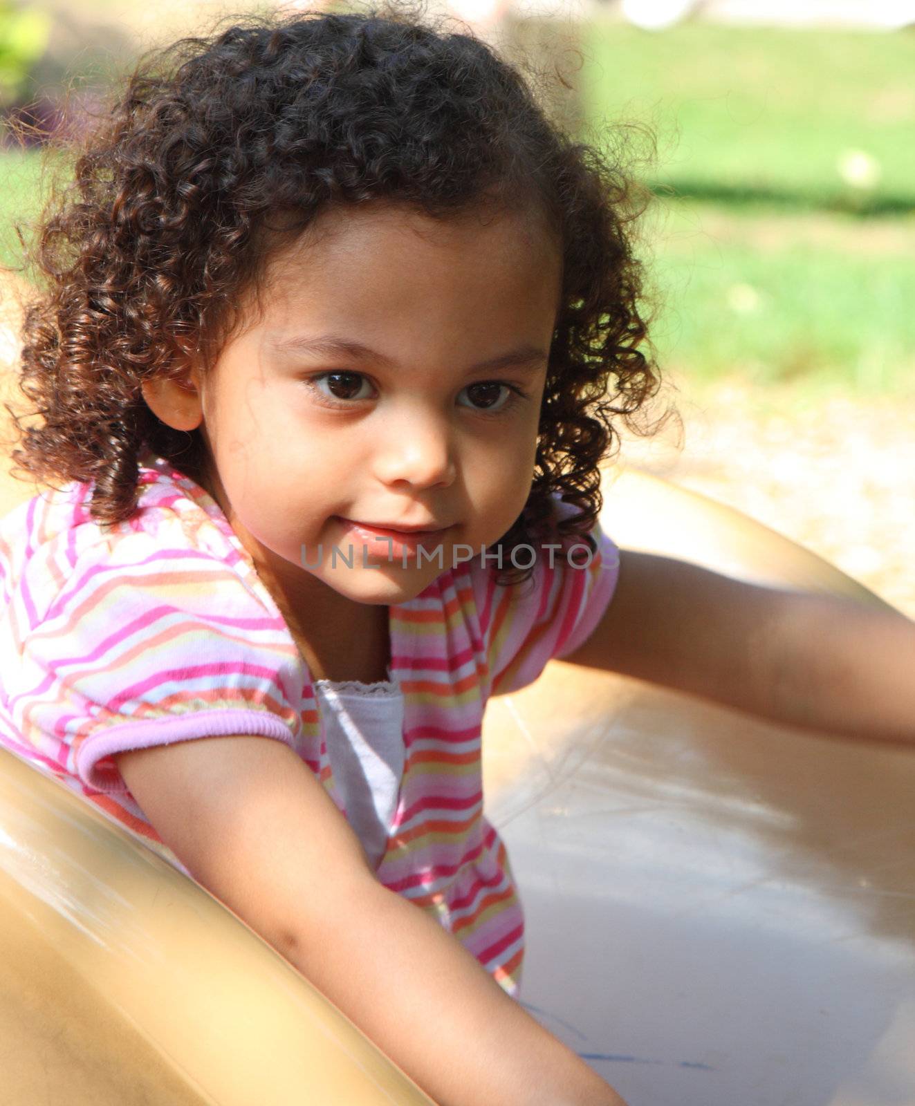 little girl on a slide in playground